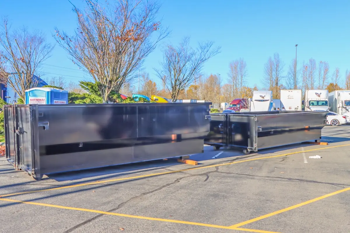 Professional dumpster rental service with roll-off container on residential driveway in Redwood Falls